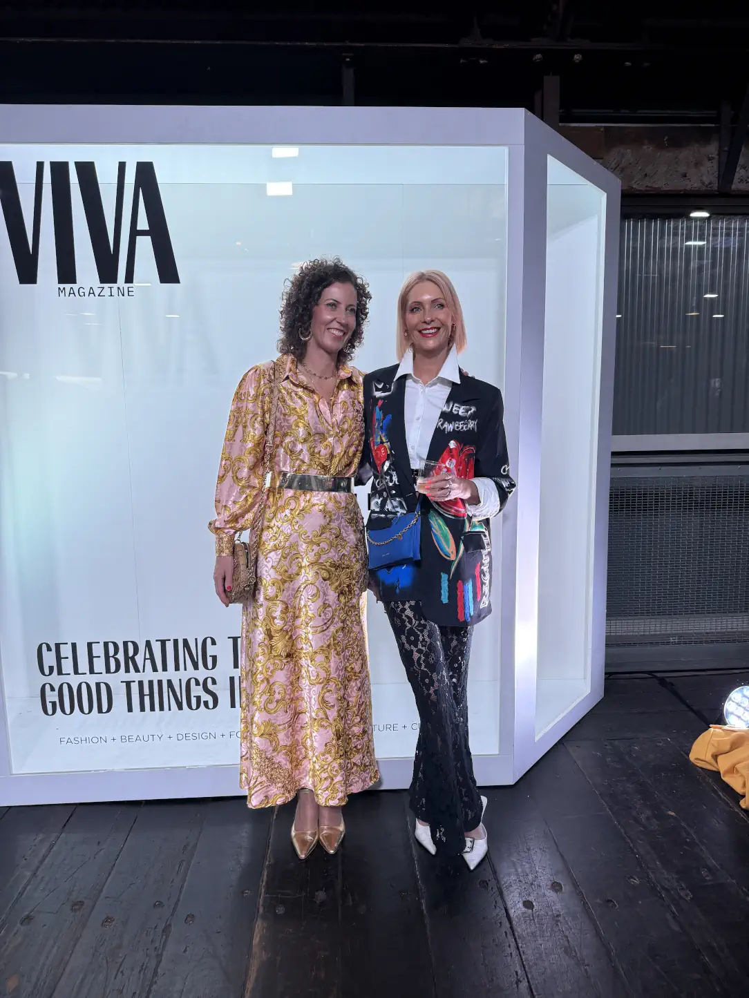 Stephanie Rumble and Mel Radford-Brown pose together at Viva Magazine’s Fashion Week event, both dressed in standout statement outfits.