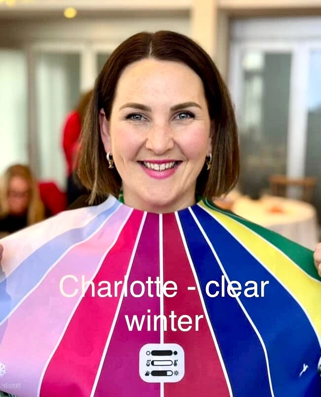 Stephanie Rumble’s happy client Charllote smiles during a colour analysis session, wearing a Clear Winter drape to reveal her best shades.