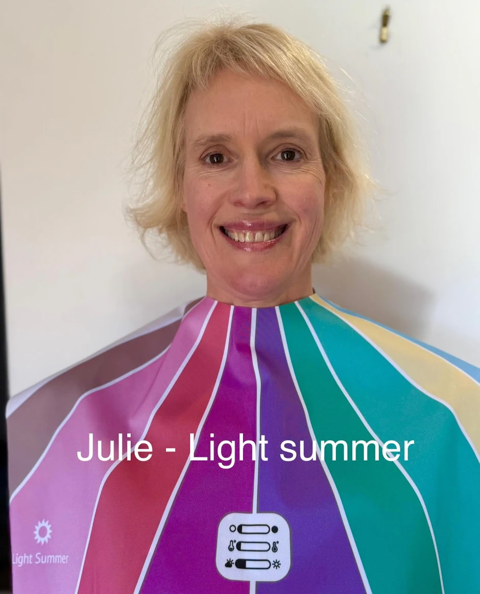 Stephanie Rumble’s happy client Julie smiles during a colour analysis session, wearing a Light Summer drape to reveal her best shades.