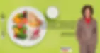 Stephanie Rumble stands confidently in a brown checked suit beside a bright green background. Next to her is a plate filled with colorful whole foods—fruits, vegetables, grains, and protein—alongside a glass of milk.