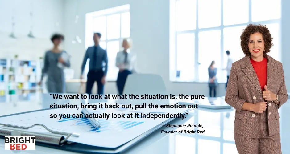 Stephanie Rumble standing confidently in a brown suit beside a blurred office background with a quote about emotional awareness.