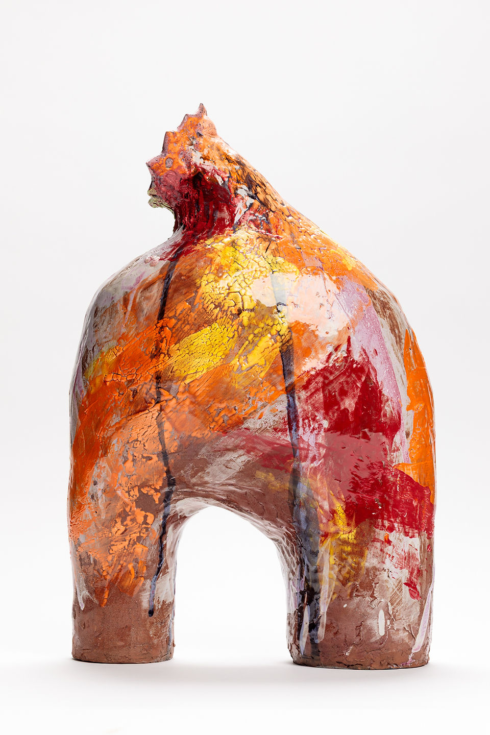 A whimsical, colourful, creature-like ceramic sculpture.