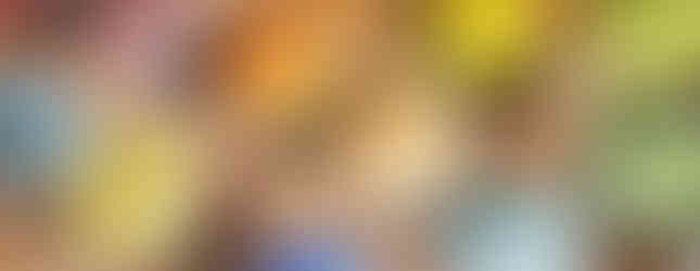 Different coloured ceramic glazes in containers.