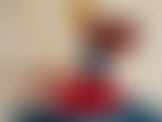 Painting of a woman with a gold crown and brown hair sitting in a puddle.