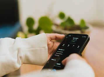 A person holding a phone showing an Instagram feed