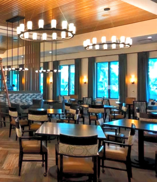Eye-level view of a professional cleaner vacuuming an office carpet