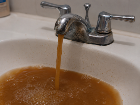 Rusty water in bathroom sink