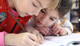girls writing in notebook