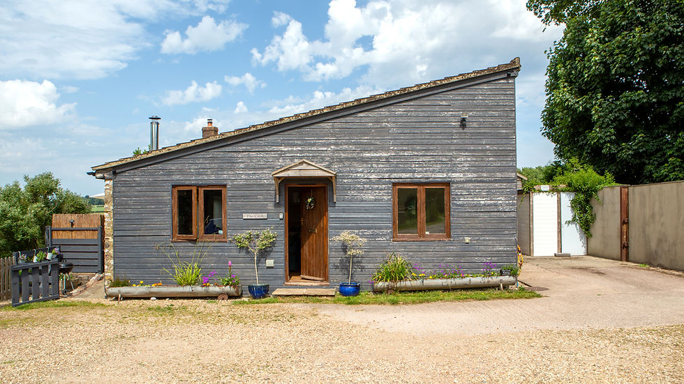 Eye-level view of the Croft at Warrens Farm surrounded by lush greenery