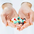 Hands holding pills