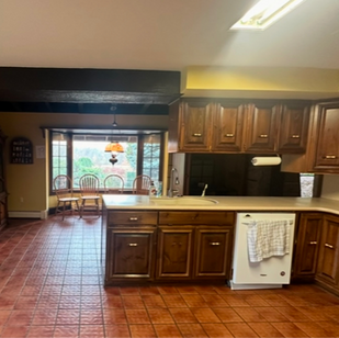 The dated ceiling light needed to be replaced with recessed lighting and the hanging cabinets were eliminated to open up the kitchen. The soffit will be painted so it blends in with the ceiling.