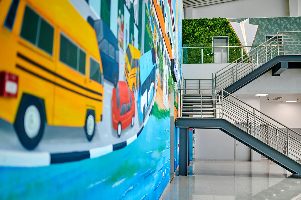 Colourful mural depicting Lagos city transport culture with adjacent green wall, adding local identity to the airport interior.