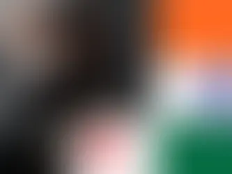 Free Fire Character in a mask with gray hair, intense gaze, and gloved hand. Indian flag on the right. Free Fire developer Garena logo at the bottom. Futuristic vibe.