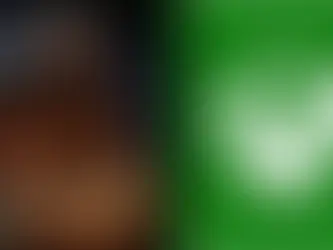 Bearded man in fur armor sits pensively in dim icy cave is Kratos from GOD OF WAR video game on PlayStation. Green background with white Xbox logo on the right. Mysterious mood.