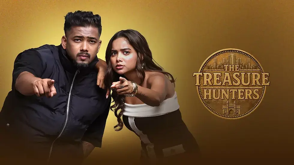 ScoutOP and Manisha Rani pointing intensely, one arm around the other, against a gold background with "The Treasure Hunters" text and coin design.