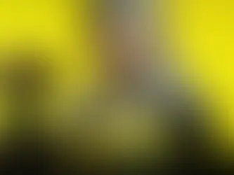 Silver-haired woman with intense gaze holds a drink can. Yellow background, bold text "LIVING LEGEND" and "EXTRACT TO BE A LEGEND." Mood: dramatic.