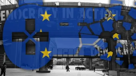 European Parliament building with blue EU flag overlay, yellow stars, and "DEMOCRACY IN ACTION" text. Monochrome people walking below.