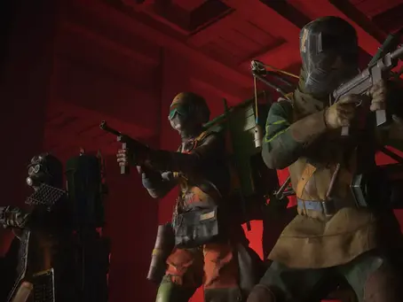 Three figures in protective gear hold weapons in a dimly lit, red industrial setting, creating a tense and ominous atmosphere. its FBC: Firebreak gameplay.
