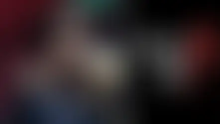 Young character with dark hair in a fur-lined coat, intense gaze. Red and green backdrop. Text: Lies of P, stylized in white and red.