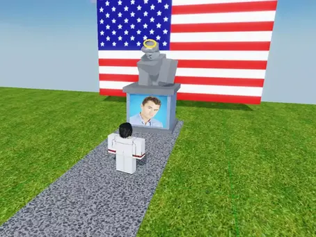 A Roblox experience where a statue with a portrait of Charlie Kirk, against a backdrop of the U.S. flag.