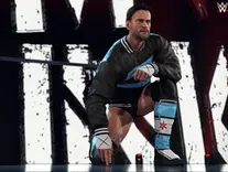 A wwe wrestler CM PUNK kneels in a black jacket and blue gear with stars, on a stage. Bold "INK" text and WWE 2K26 logo are visible in the background.