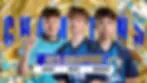 Three young men in sports jerseys stand proudly with "FNCS 2025 Champions" text. Gold, blue, and white colors dominate the celebratory background.