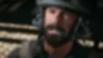 Bearded man from Battlefield 6 reveal trailer wearing a headset and helmet looks intense, sitting inside a vehicle. Striped shadows on metal background.