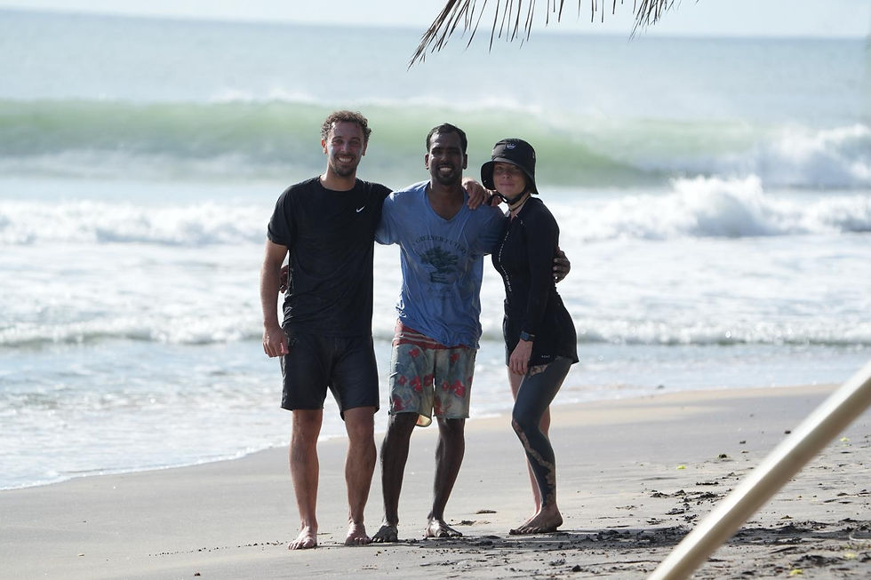 Smiling group on Arugam Bay beach after surf lesson