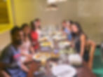 Group of people enjoying dinner together at a long table