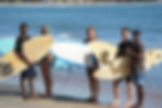 Surfers with boards on beach, Arugam Bay surf camp