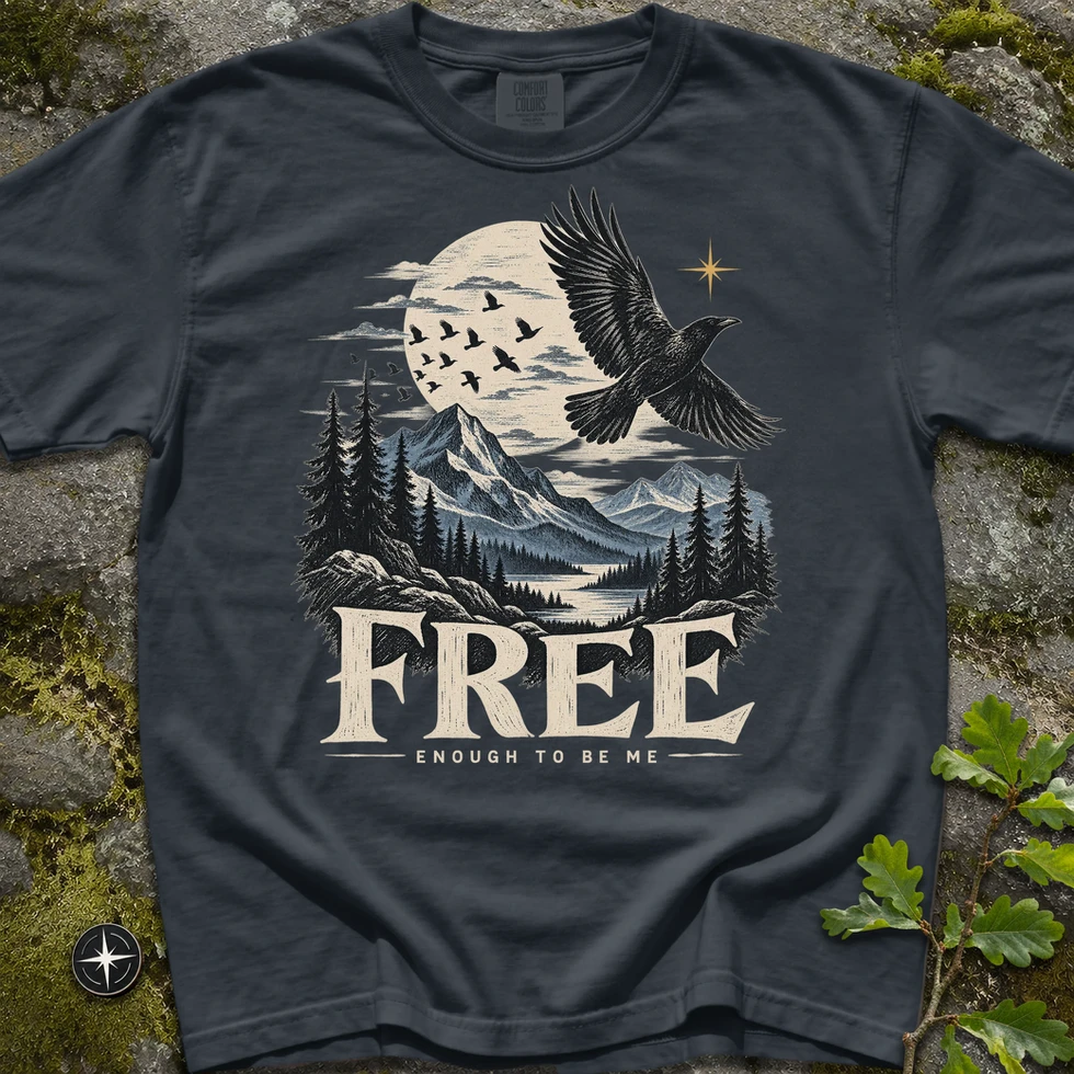 My Real North Free Raven T-Shirt i mörkgrått, tryck med flygande korp över bergslandskap och texten "Free, enough to be me"