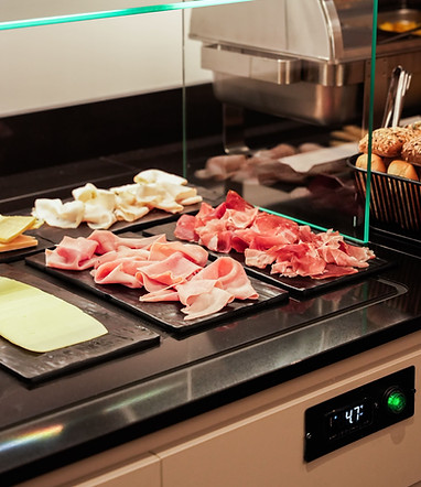 Selection of cold cuts and fresh cheeses at the breakfast buffet of Hotel Maritan in Padova.