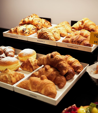 Tray of freshly baked croissants, plain, whole grain, and chocolate, served at the breakfast buffet.