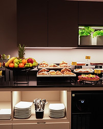 Showcase with donuts, waffles, fruit, and assorted sweets at the breakfast buffet of Hotel Maritan in Padova.