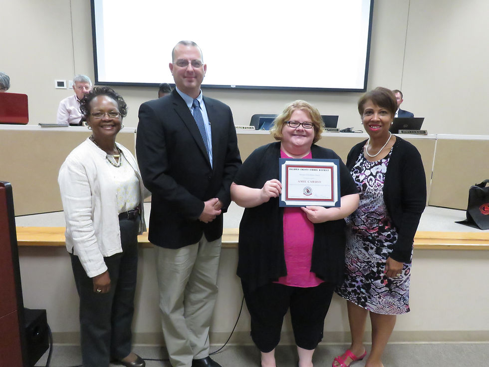 Annie Caruso receiving the boards recognition.