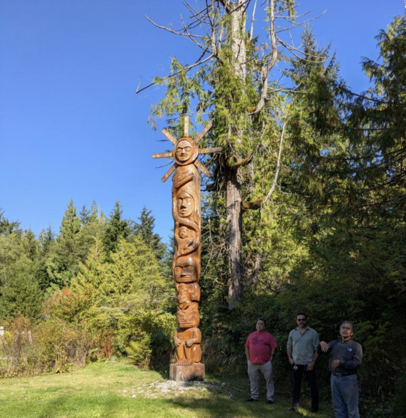 Knowledge Holders Seitcha, Eli Enns, and Elder Joe Martin at the Naa’was Totem Pole sharing the pole’s story, carved by Joe Martin. 