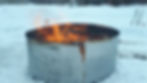 Biochar burner pictured at Hawk Feather Farms. Flames billow from the top of a circular above ground steel pit used for making BioChar.