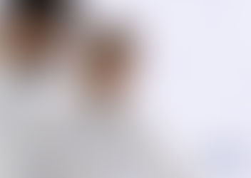 Two laboratory professionals in white coats review information together against a light background with subtle laboratory imagery.