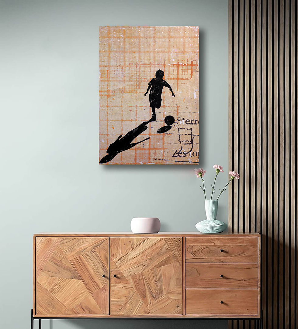 on light green wall above wooden cabinet orange checkered artwork with silhouette boy playing football