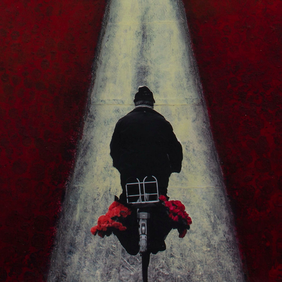 Thumbnail: Man in black on bicycle rides through red tulip field with red flowers on back of bicycle