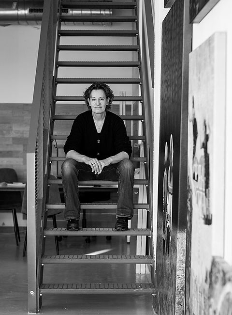 db waterman in Black and white sitting on metal stairs in studio gallery