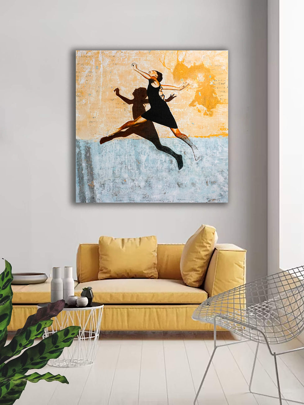 square artwork with jumping girl and her shadow against yellow and blue concrete wall above yellow couch
