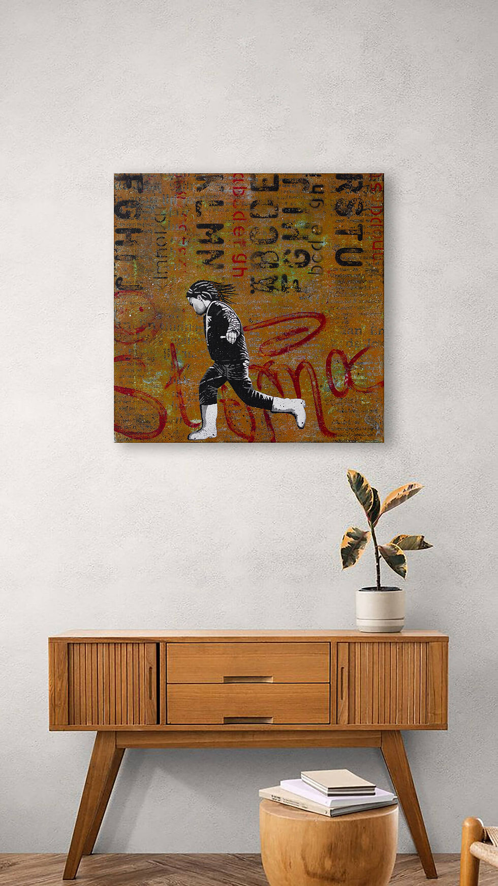 Thumbnail: On white wall above wooden cabinet hangs square ocher street art with red and black tags and monochrome running boy
