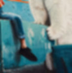 Thumbnail: jeans leg and paws of polar bear on aqua blue weathered concrete