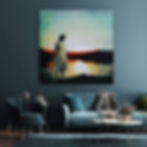 Blue grey wall and dark couch with square landscape painting above, of woman standing in water
