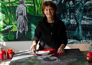 artist db waterman behind table at work in front of green artworks