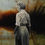 Thumbnail: torso of woman in black and white standing against a hazy dark sunset background with orange, black and sienna colours