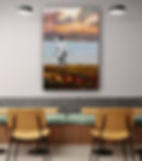 Vertical red poppies in ocher grass landscape art, with girl and skipping rope, on wall above large wooden table and benches