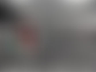 Monochrome beach landscape with cracked earth and girl in red bathing suit and green bucket