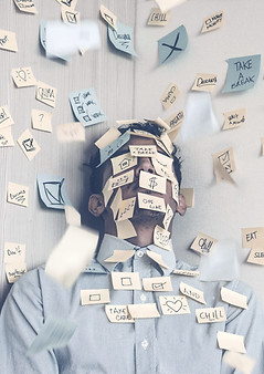 Young man covered in sticky notes, work